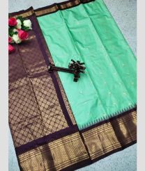 cyan and silver colour gadwal pattu sarees with All over Buttas design