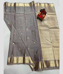 grey colour kanchi pattu sarees with All over Buttas design