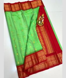 light green colour gadwal pattu sarees with All over Buttas design