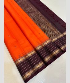 coral red colour kanchi pattu sarees with All over Buttas design