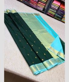 green and silver colour kuppadam pattu sarees with All over design