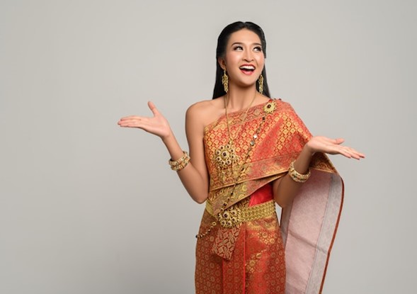 A woman gracefully draping a Tripura silk saree.
